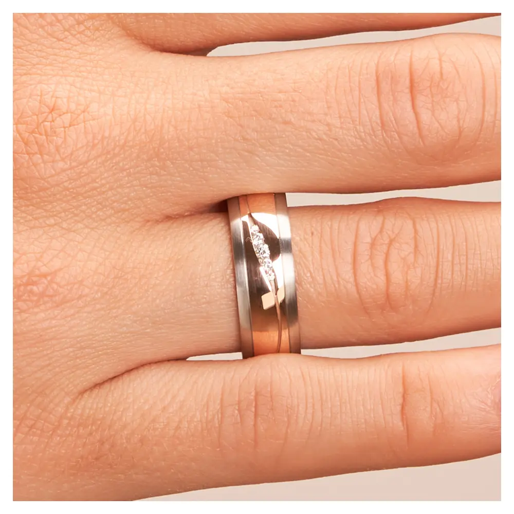 Stahl&Rotgold Ehering mit fünf Diamanten in sandmattem Rillen auf Hand im Zoom