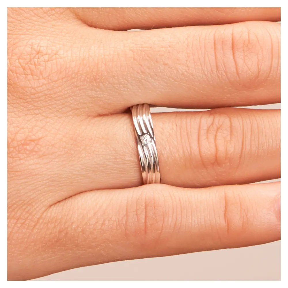 Ehering mit geschwungenen Rillen aus poliertem 925er Silber mit Diamanten auf Hand im Zoom