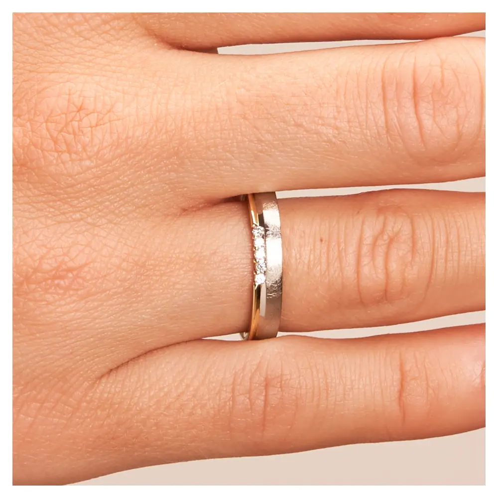 Bicolor Ehering aus 585 Gelbgold & Platin sandmattiert mit 5 Diamanten auf Hand im Detail