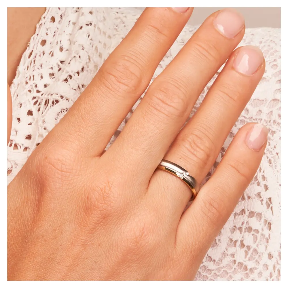 Bicolor Ehering aus 585 Gelbgold & Platin mit 3 Diamanten in Vertiefung auf Hand am Gesicht im Zoom