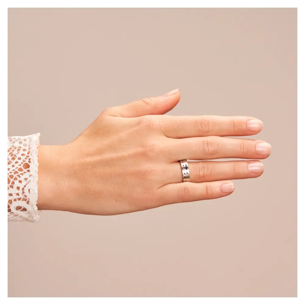 Eheringe aus platiniertem Silber 925 mit Rillenmuster und Diamanten auf Hand