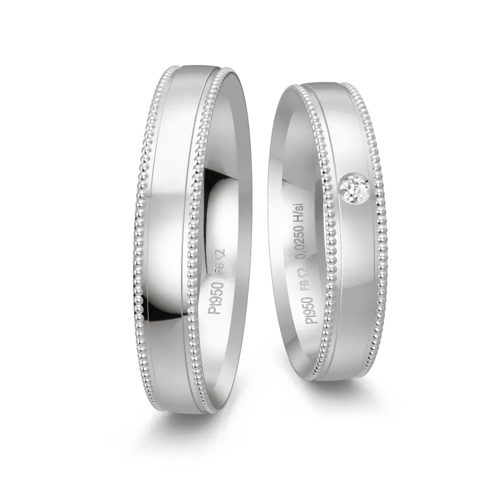 Eheringe aus Platin poliert mit Diamanten und Millgriffmuster am Rand