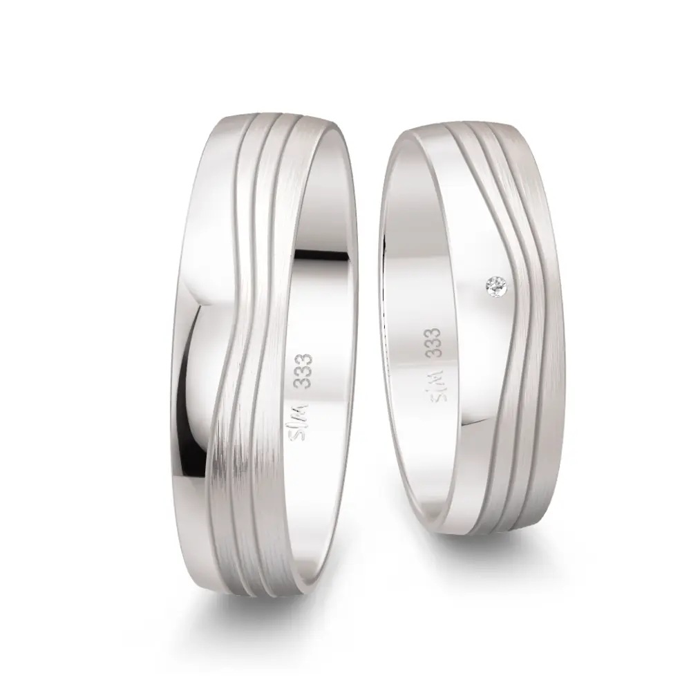 Weissgold Trauringe mit Diamant und welligem Rillenmuster