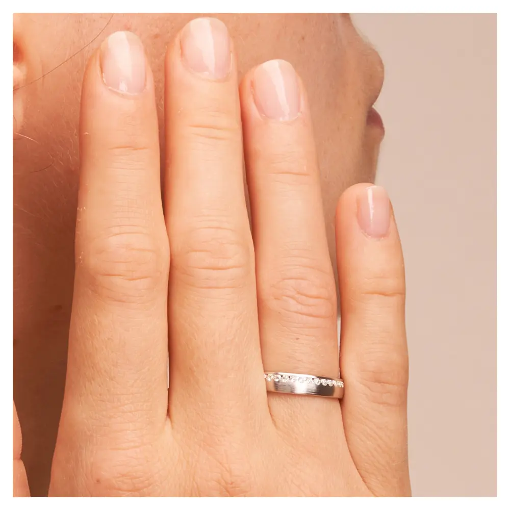 Silber 925 Verlobungsring mit Zirkonia und Mattierung auf Hand am Gesicht im Zoom