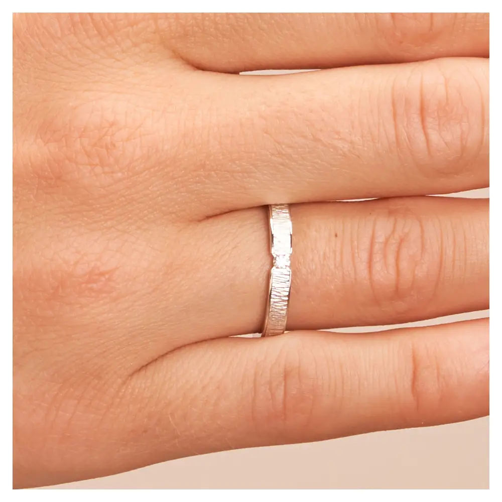 Eheringe aus rhodiniertem Silber 925 mit Zirkonia und Strukturierung auf Hand