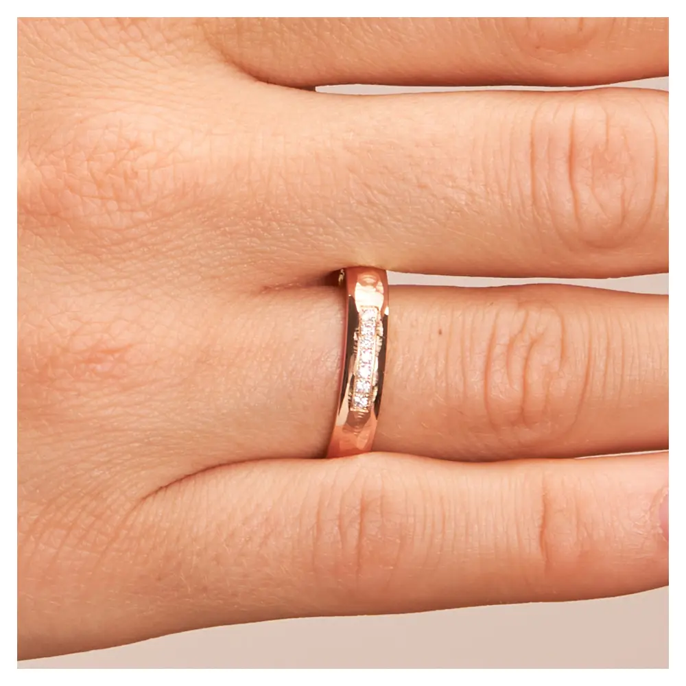Hammerschlag Roségold Eheringe mit 7 Diamanten und polierten Rändern auf Hand im Zoom