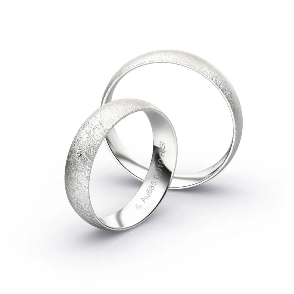 Aufnahme von schlichten eismatten Trauringen aus Weissgold mit Diamant mit 5 mm Breite