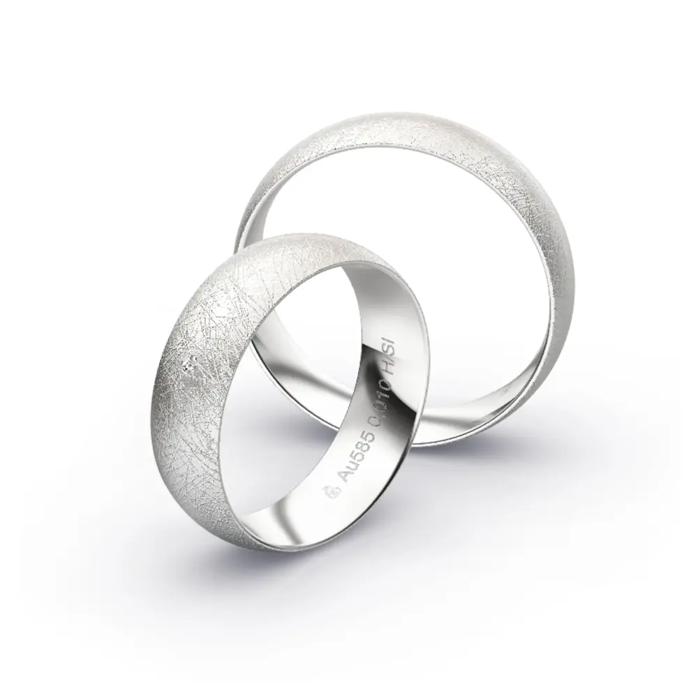 Aufnahme von schlichten eismatten Trauringen aus Weissgold mit Diamant mit 6 mm Breite