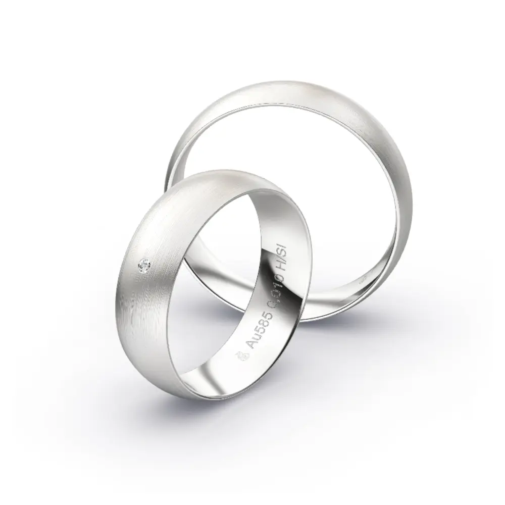 Aufnahme von schlichten matten Trauringen aus Weissgold mit Diamanten mit 6 mm Breite