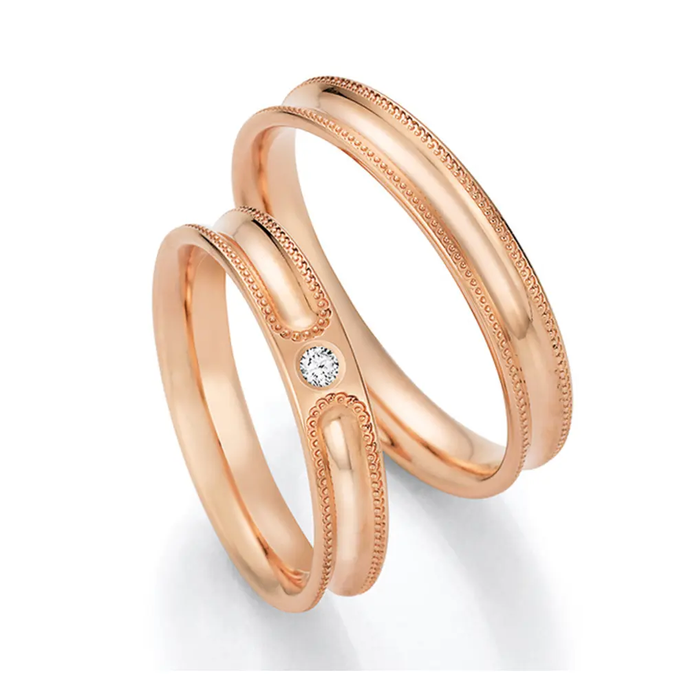 Rotgold Eheringe konkav mit Millgriff und Diamanten
