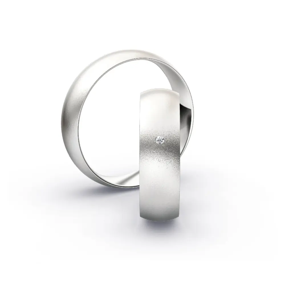Aufnahme von schlichten sandmatten Trauringen aus Weissgold mit Diamanten mit 6 mm Breite