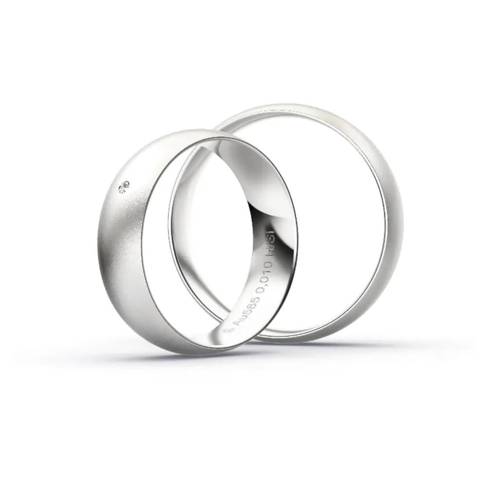 Aufnahme von schlichten sandmatten Trauringen aus Weissgold mit Diamanten mit 6 mm Breite