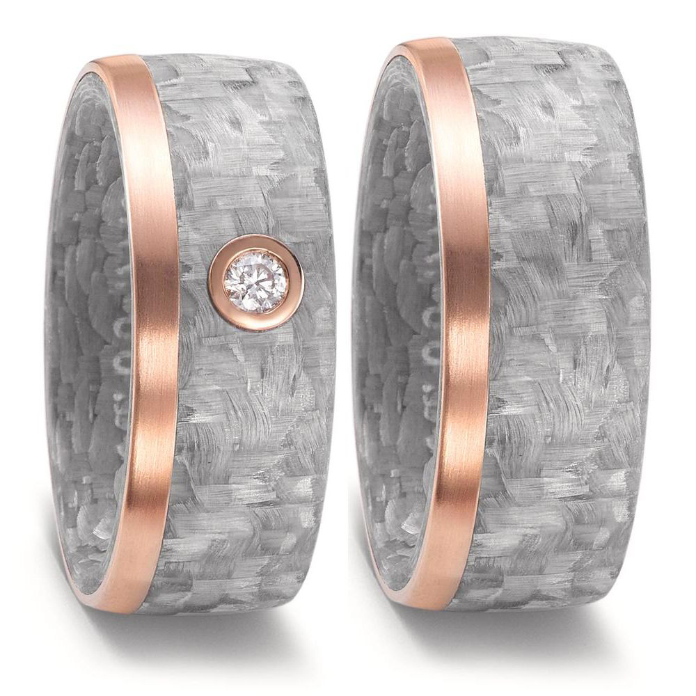 Aufnahme von Trauringen aus grauem Carbon & Rotgold und weißem Diamanten