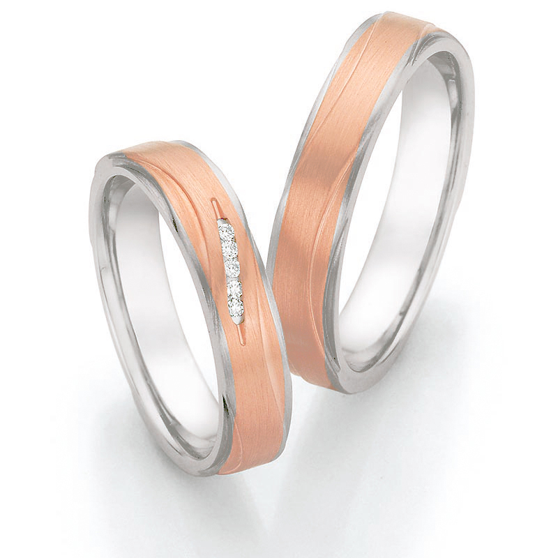 Aufnahme von Roségold & Edelstahl Eheringen mit 5 weißen Diamanten in eleganter Vertiefung