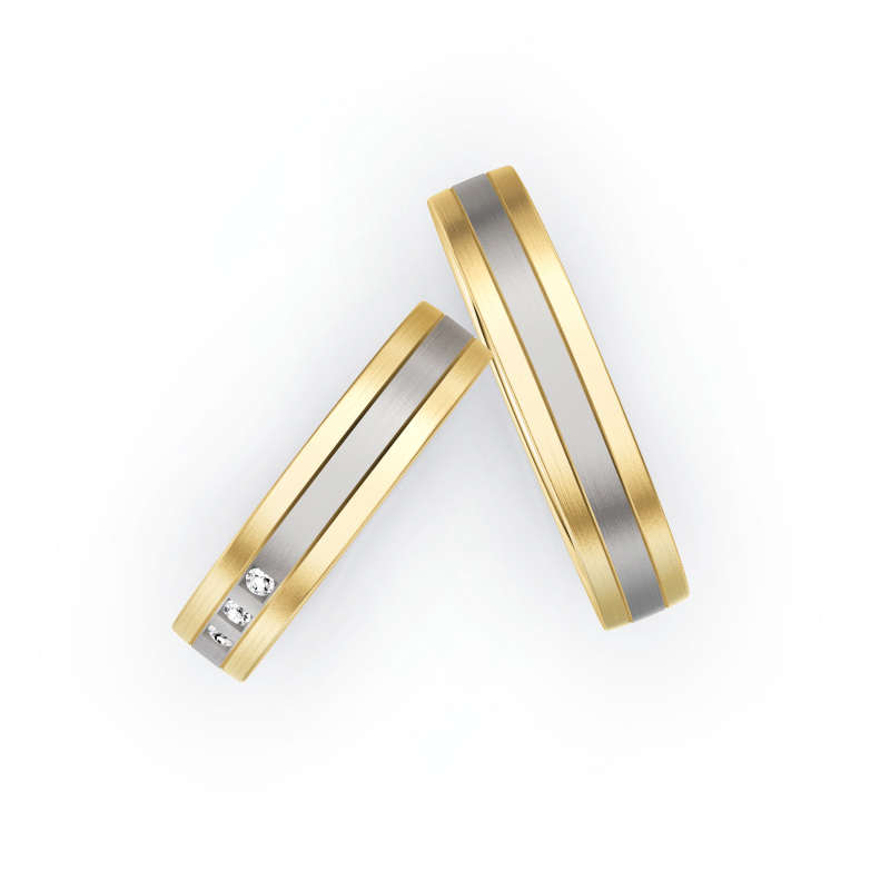 Aufnahme von Trauringen in Gelbgold und Palladium 500 längsmatt mit drei weißen Diamanten 