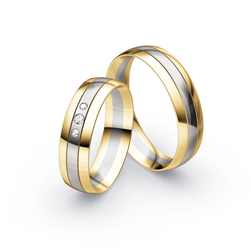 Aufnahme von Trauringen aus Palladium 500 & Gelbgold bicolor mit drei runden Diamanten 