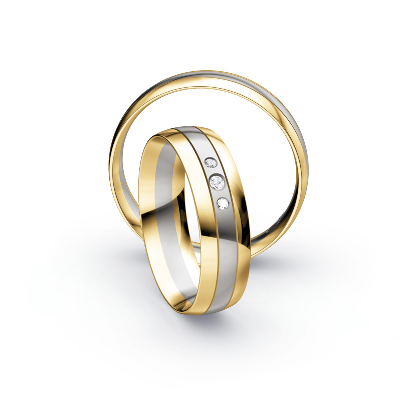 Aufnahme von Trauringen aus Palladium 500 & Gelbgold bicolor mit drei runden Diamanten 