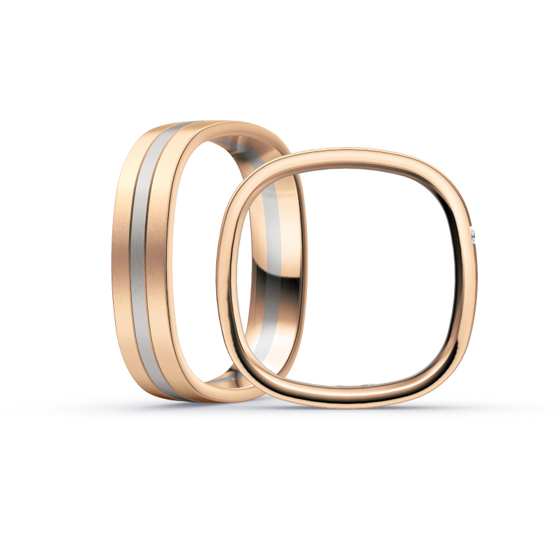 Aufnahme von Trauringen aus Rosègold/Palladium 500 mit seitlich gesetzten weißen Diamanten 