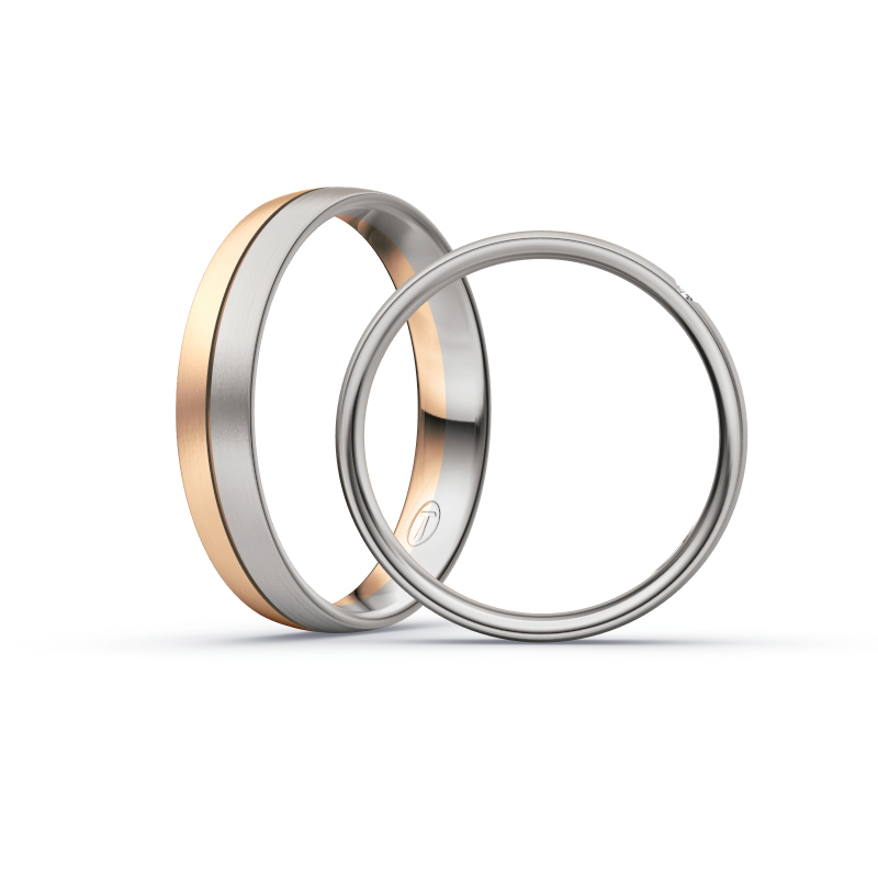 Aufnahme von Trauringen in Palladium 500 und Roségold längsmatt mit drei Diamanten in ovaler Fassung