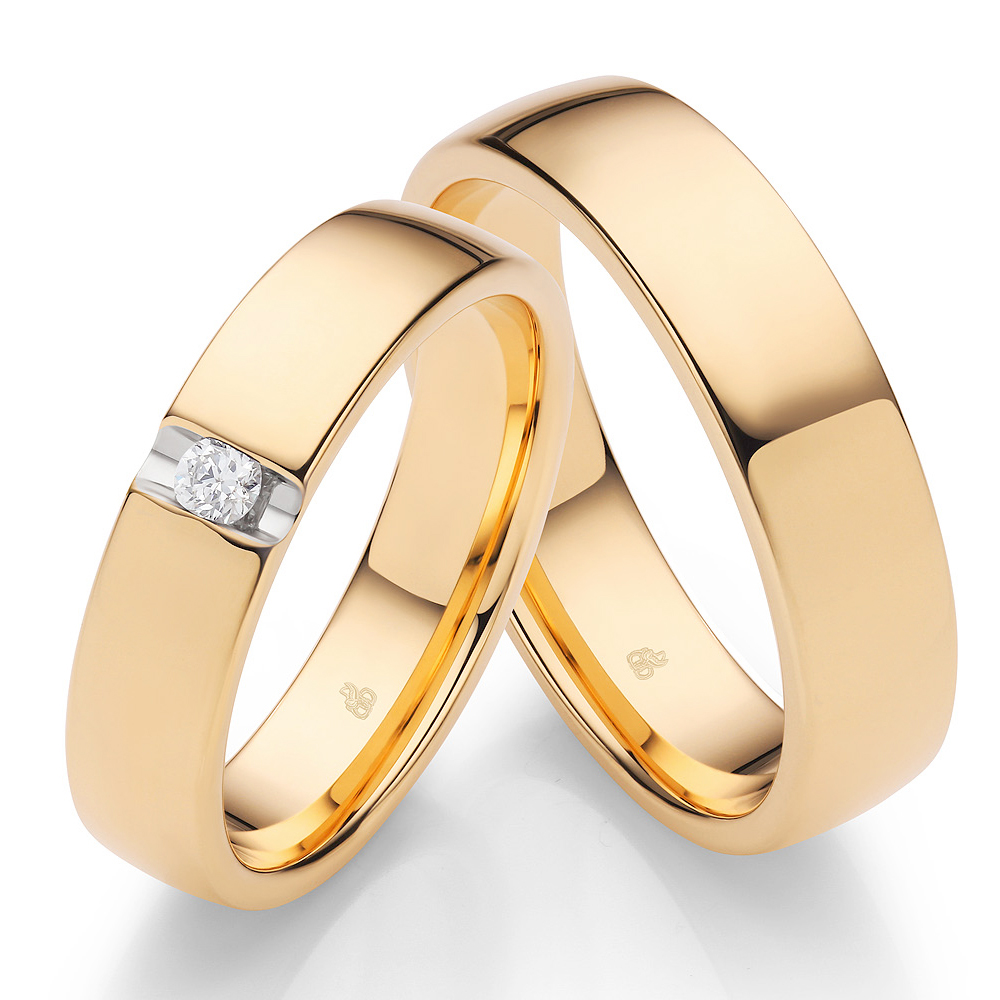 Eheringe aus poliertem Sommergold mit einem Diamant