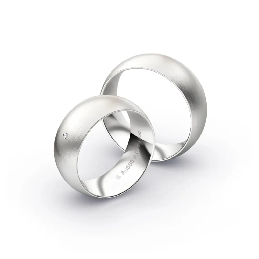 Aufnahme von Trauringen aus Weissgold mit Längsmattierung und Diamanten