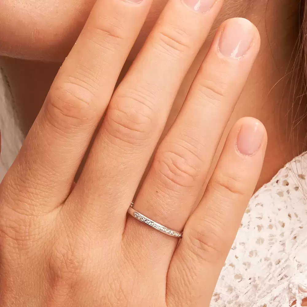 Eheringe aus mattem Weißgold in schmalem Design mit 15 Diamanten auf Hand im Zoom