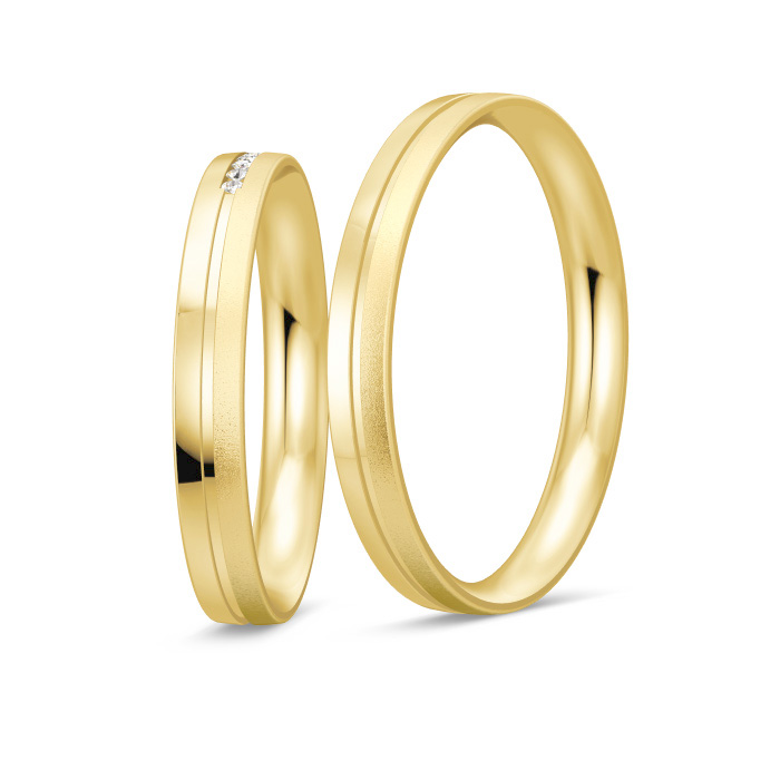 Aufnahme von schmalen Eheringe aus Gelbgold mit Diamanten und prominenter RIlle