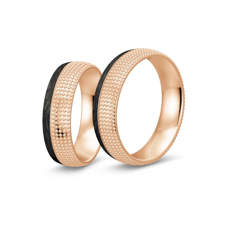 Aufnahme von taktilen Eheringe aus Rosegold und Carbon mit Diamanten und Kreismuster 
