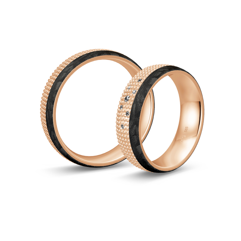 Aufnahme von taktilen Eheringe aus Rosegold und Carbon mit Diamanten und Kreismuster 