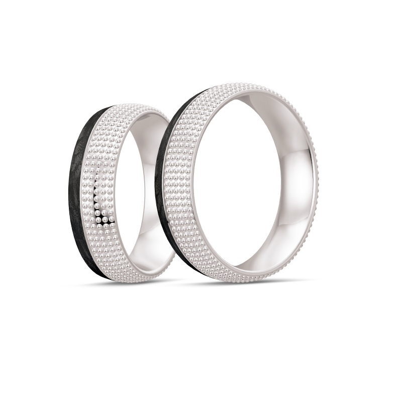 Aufnahme von taktilen Eheringe aus Weißgold und Carbon mit Diamanten und Kreismuster