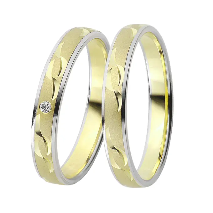 Gelbgold und Weissgold Eheringe mit Sichelmustern und Diamant