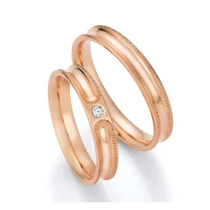 Rotgold Eheringe konkav mit Millgriff und Diamanten