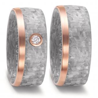 Aufnahme von Trauringen aus grauem Carbon & Rotgold und weißem Diamanten