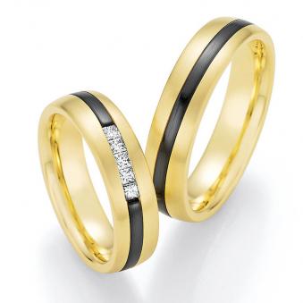 Aufnahme von Trauringen aus Gelbgold & Zirconium bicolor mit fünf viereckigen Diamanten 	