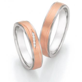 Aufnahme von Roségold & Edelstahl Eheringen mit 5 weißen Diamanten in eleganter Vertiefung