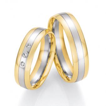 Aufnahme von Trauringen aus Palladium 500 & Gelbgold bicolor mit drei runden Diamanten