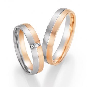 Aufnahme von Trauringen in Palladium 500 und Roségold längsmatt mit drei Diamanten in ovaler Fassung