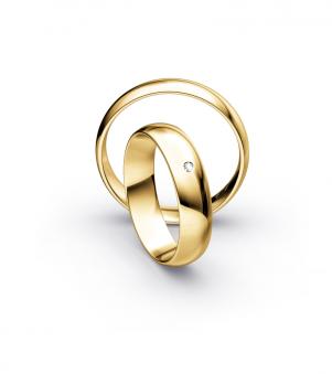 Aufnahme von Trauringen aus poliertem Gelbgold mit weißem Diamanten