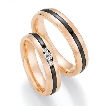 Aufnahme von Eheringen aus Roségold & Zirconium mit drei Diamanten in ovaler Fassung 