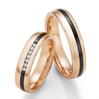 Aufnahme von Eheringen aus Roségold mit asymmetrischem Zirconiumstreifen und sieben Diamanten 