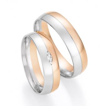Aufnahme von Trauringen in Rotgold/Weißgold mit drei Diamanten in blattförmiger Fassung