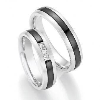 Aufnahme von Trauringen aus Weißgold mit mittigem schwarzem Zirconiumstreifen mit drei Diamanten 
