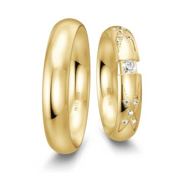 Eheringe aus poliertem Gelbgold mit großem Diamanten in Spannfassung und mehreren kleinen Diamanten