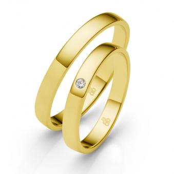 Aufnahme der Trauringe aus poliertem Gelbgold mit Diamanten