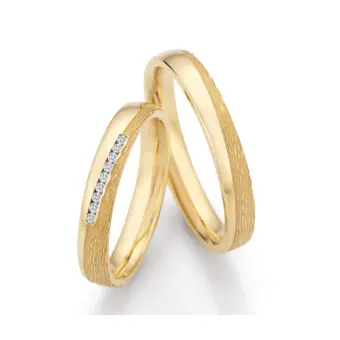 Markante Gelbold Eheringe mit 9 Diamanten im Kanal halbpoliert halbstrukturiert
