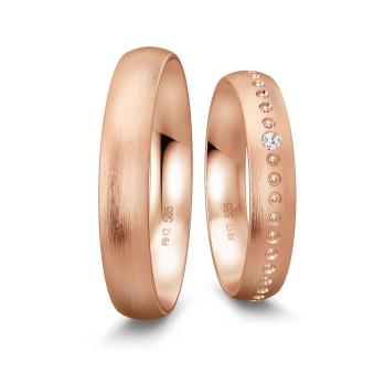 Gerundete Eheringe aus Rotgold mit Diamanten und Millgriff