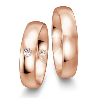 Eheringe aus poliertem Rotgold mit Diamanten und verstecktem Herz