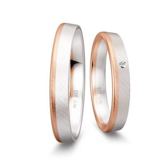 Trauringe aus mattiertem Weißgold mit Rand aus Rotgold und Diamant