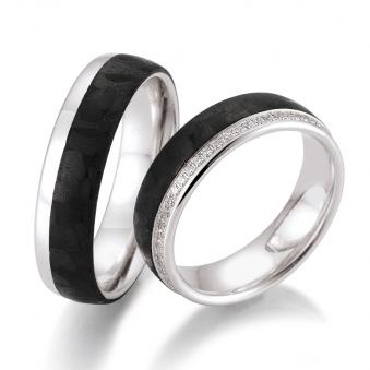 Aufnahme von Eheringen aus Weißgold und Carbon mit vielen Diamanten