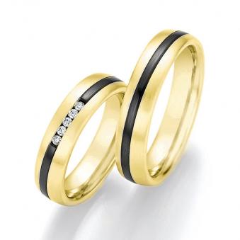 Aufnahme von Eheringen aus Gelbgold mit Diamanten und geschwungenem Streifen aus Zirconium 